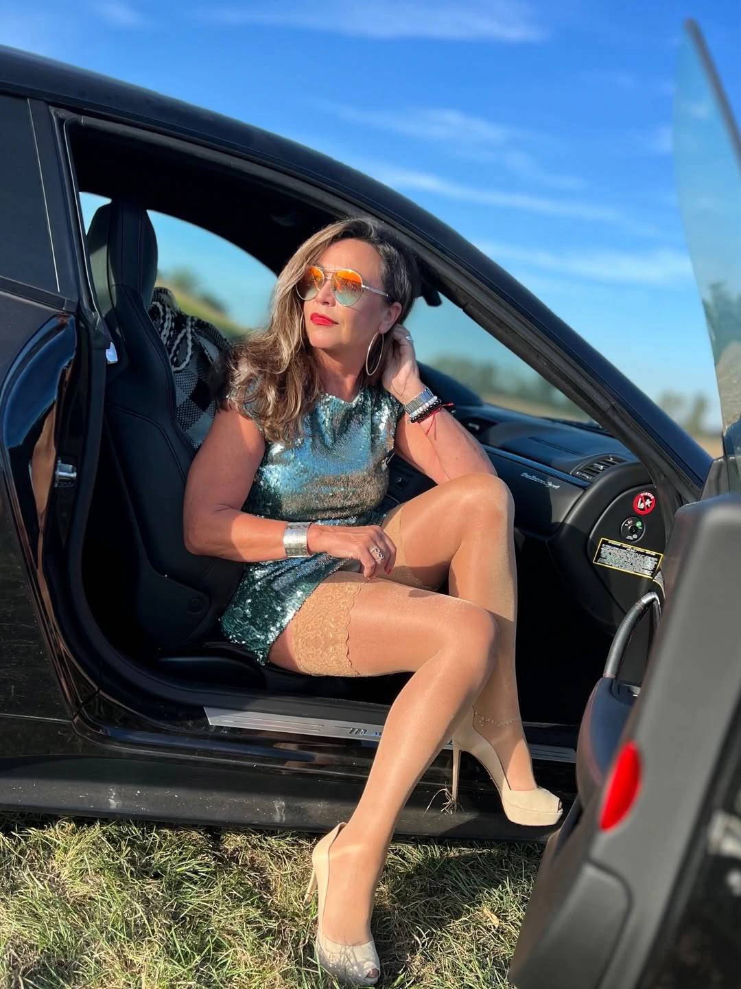 Miss giugno in auto con le autoreggenti